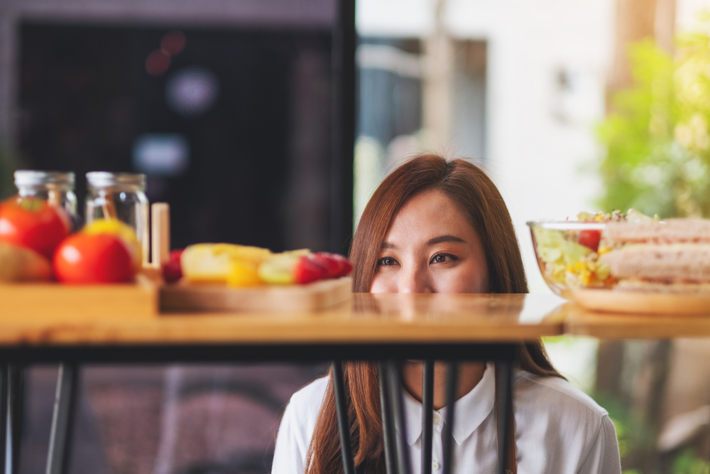 Girl looking at a table filled with food