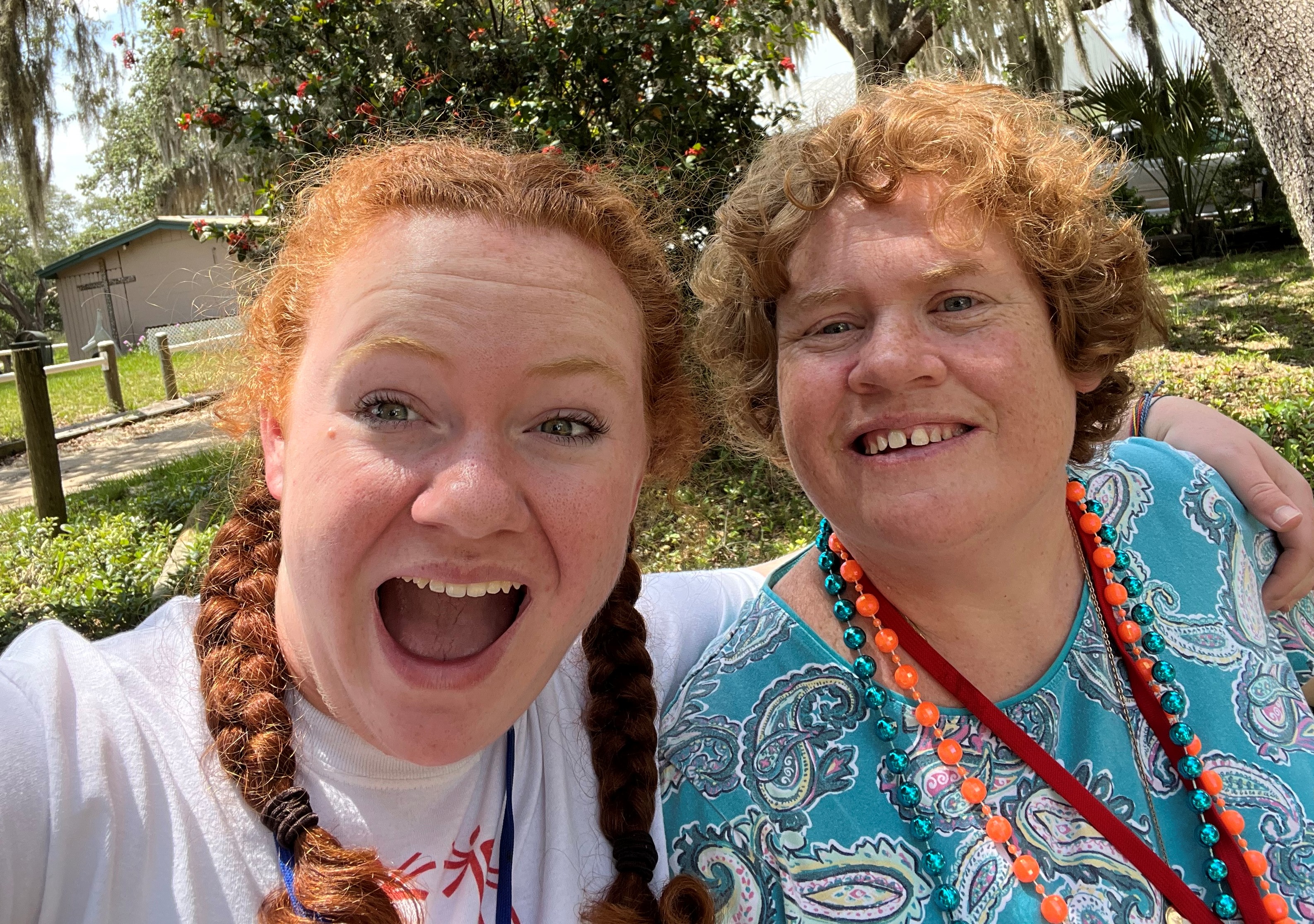 Two woman smiling and laughing for the camera