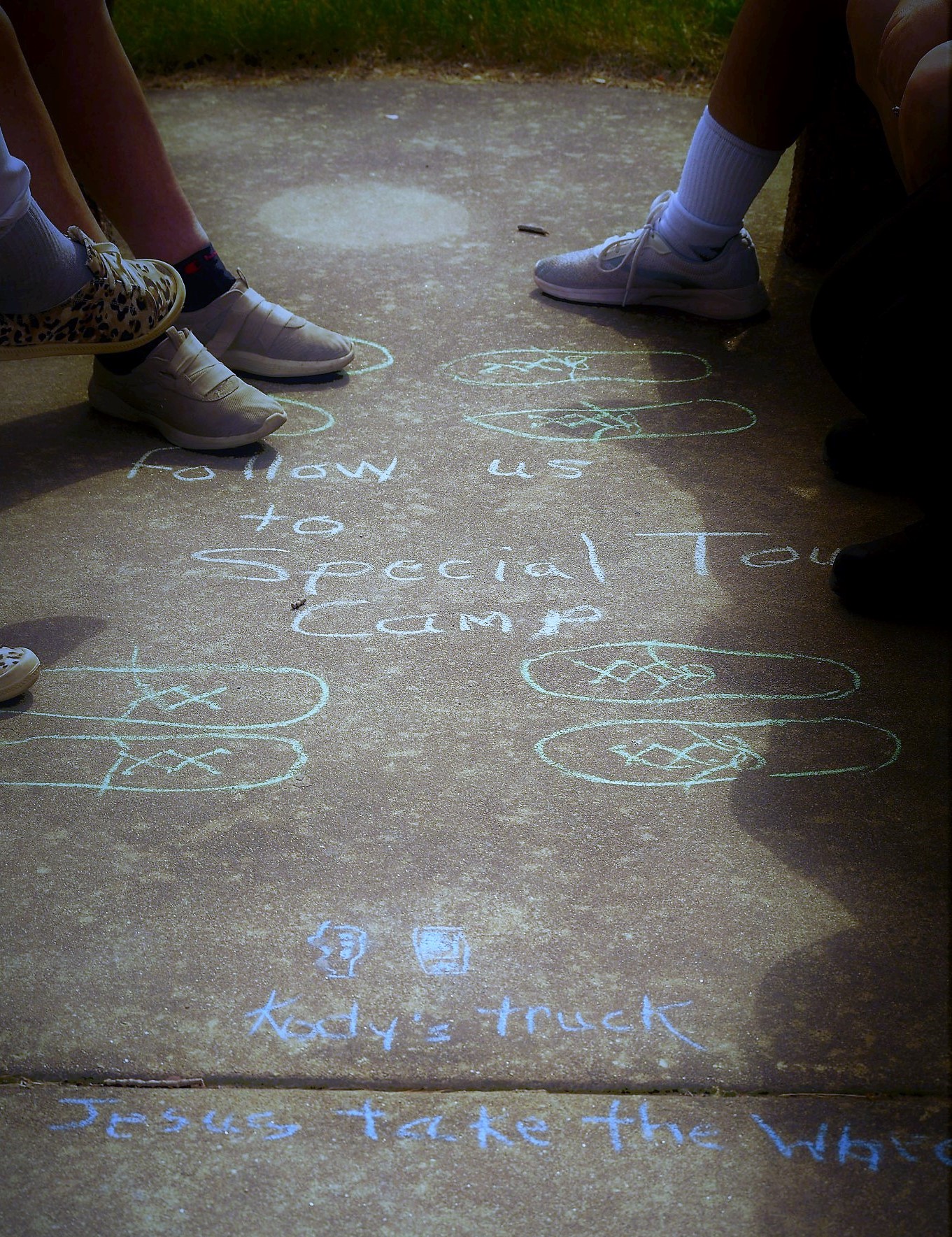 Follow us to Special Touch Camp in chalk on sidewalk with Kody's Truck Jesus take the Wheel