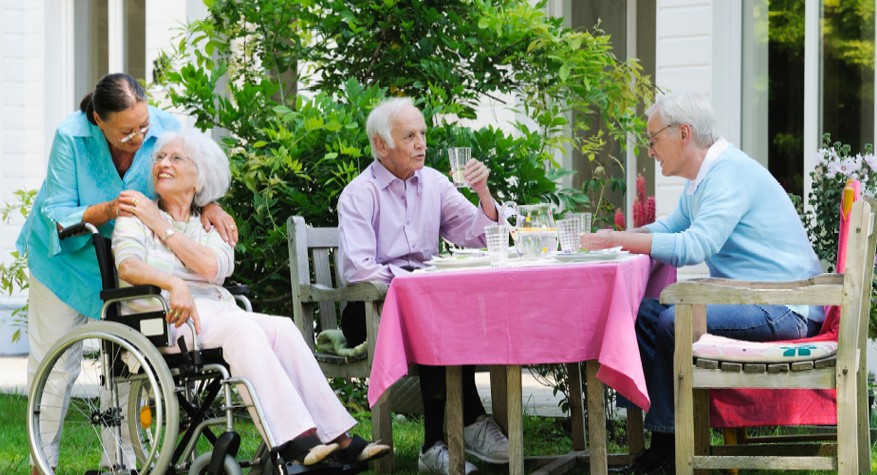 A group of people sitting together eating and talking