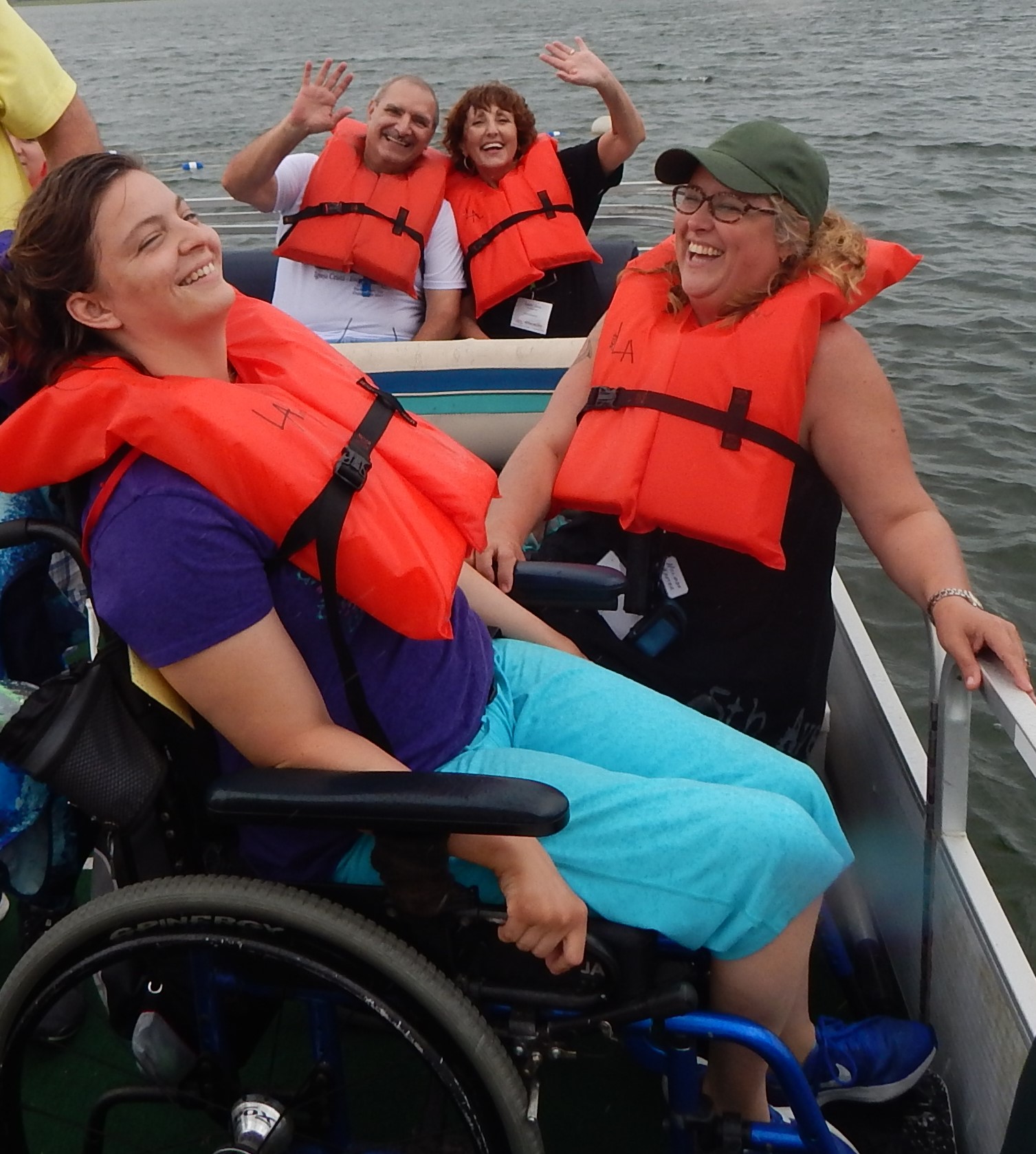 People in a pontoon boat laughing and having fun