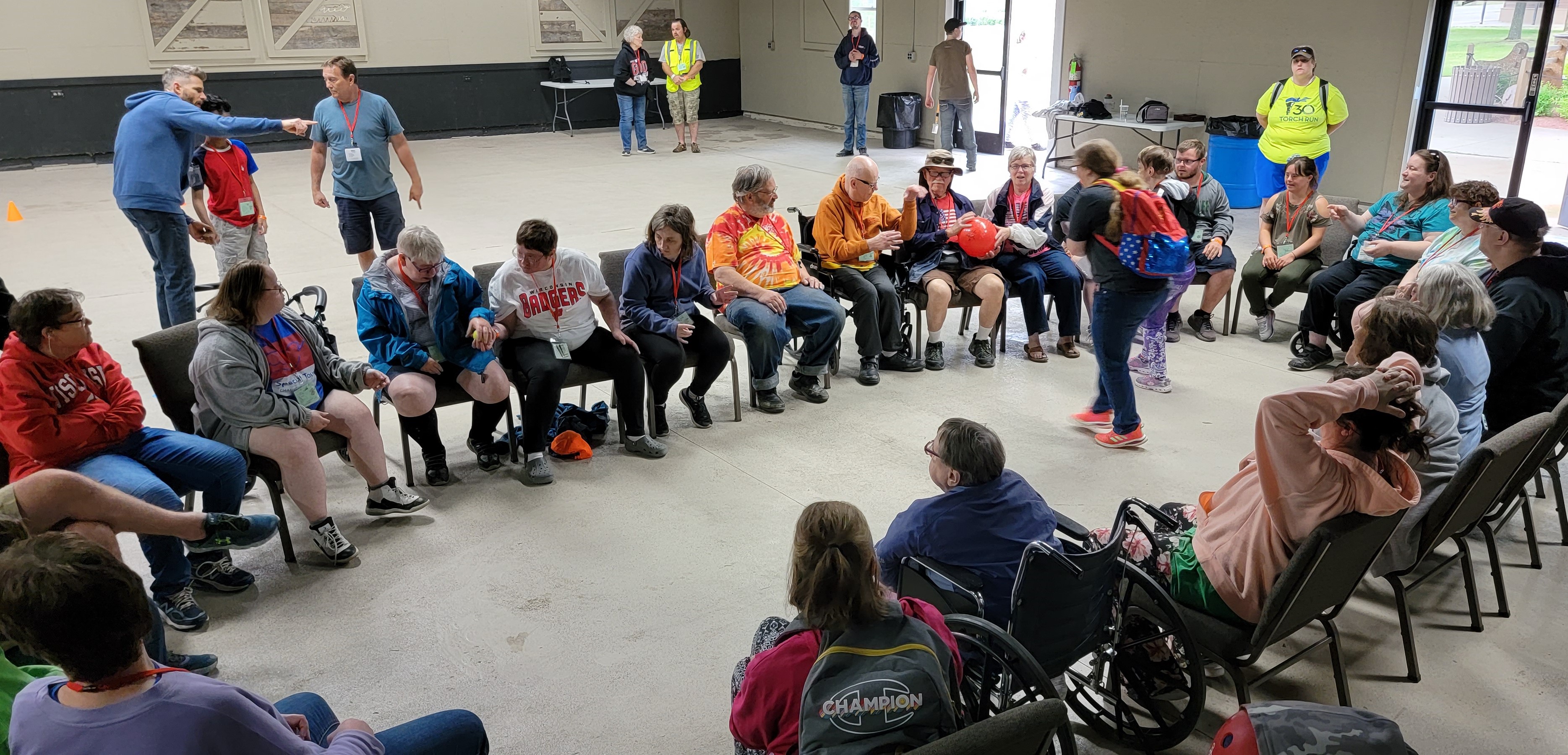 A group of people sitting on chairs in a large circle